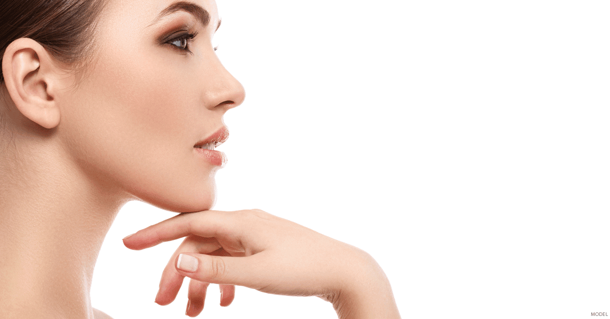 Profile of woman with sculpted jaw and cheekbone with hand touching her chin