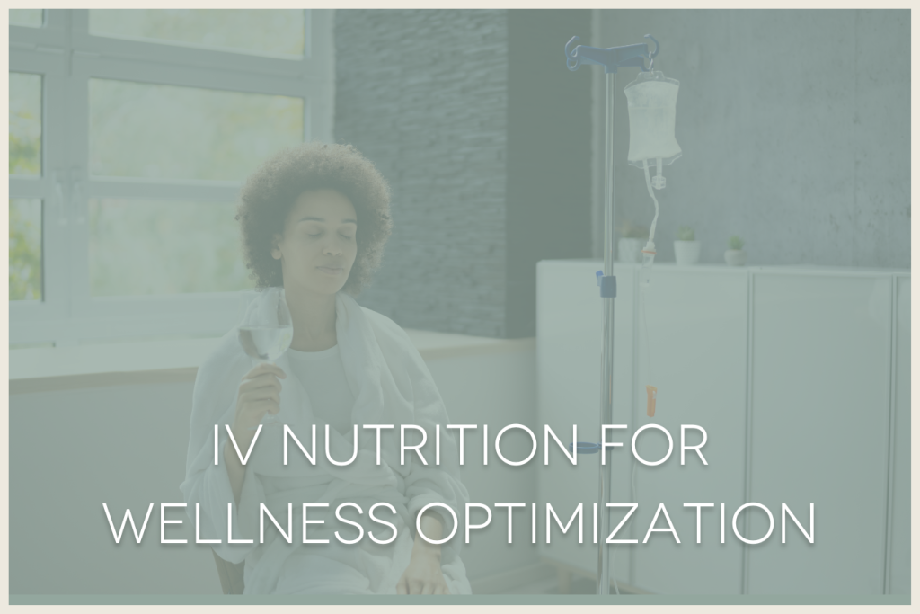African American woman sitting in a chair with her eyes closed, relaxed with a glass of water, while she receives a wellness IV drip